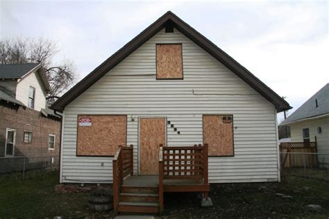 house boarded up with metal|boarding up damaged property.